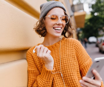 Woman listening online courses with mobile phone
